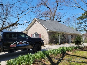 JMR Roofing truck at a home for roofing project