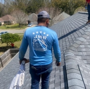 JMR Roofing team member working on a roof project